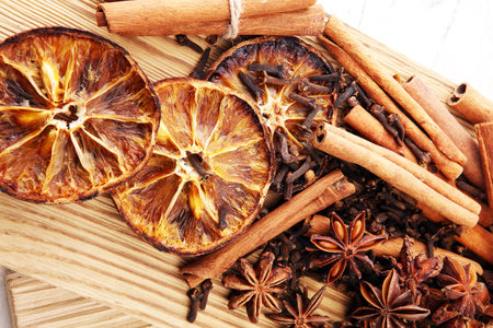 Dry orange slices, cinnamon sticks, anise and clove christmas spices decoration.