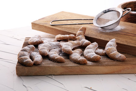 Vanille Kipferl cookies for christmas on brown wood with sugar.の写真素材