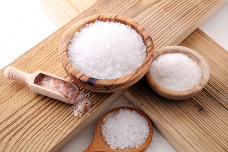 differnt kind of salt in wooden bowl and spoon.