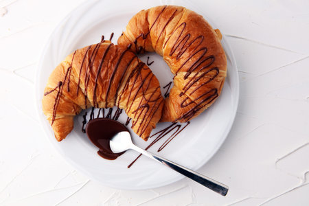 Fresh homemade croissants with chocolate. Sweet bakery concept.