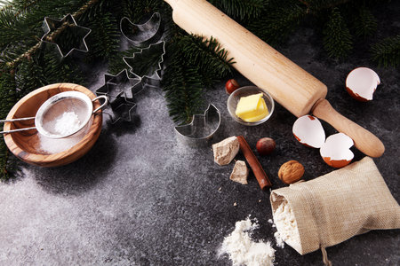 Baking ingredients for homemade pastry on wooden background with cookies and spieces.の写真素材