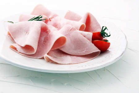 Sliced ham on white background. Fresh prosciutto. Pork ham sliced.の写真素材