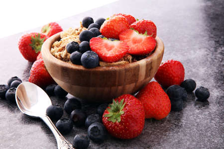 Bowl of homemade granola with  fresh berries on grey background.の写真素材