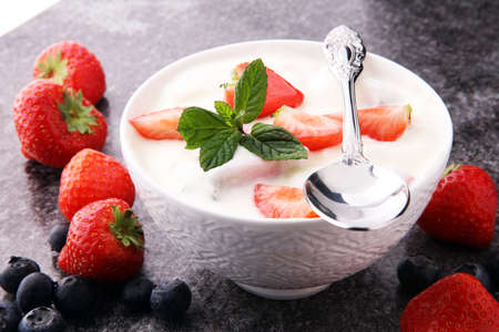 Homemade yogurt with fresh strawberry on a grey background.の写真素材