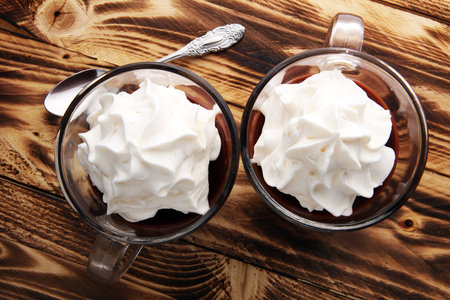 Hot chocolate or coffee with whipped cream in glass.の写真素材