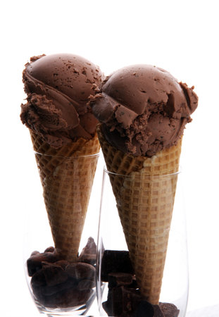 chocolate ice cream scoops with pieces of chocolate and waffle cones