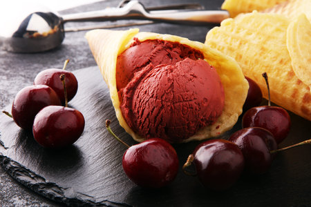 Homemade cherry ice cream on wooden background with fresh cherries