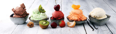 Set of ice cream scoops of different colors and flavours with berries, nuts and fruits の写真素材