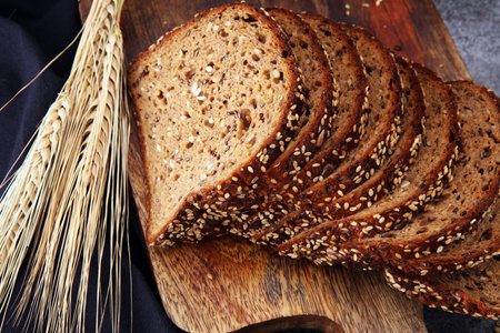 Sliced rye bread on cutting board. Whole grain rye bread with seeds
