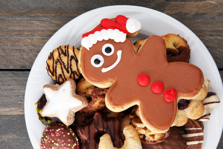 Santa claus cookie and Plate with tasty fresh Christmas cookies on  table