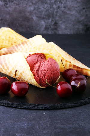 Homemade cherry ice cream on wooden background with fresh cherries