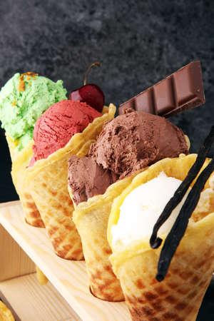 Set of ice cream scoops of different colors and flavours with berries, nuts and fruits の写真素材