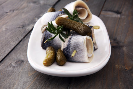 Traditional rollmops, stuffed pickled herring fillets,on a dishの写真素材