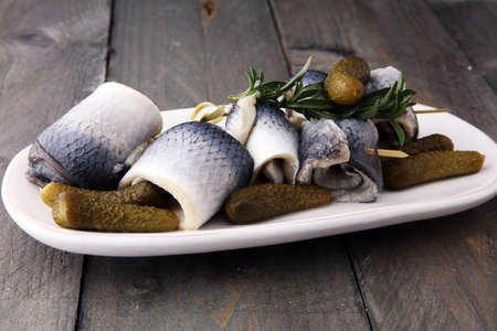 Traditional rollmops, stuffed pickled herring fillets,on a dishの写真素材