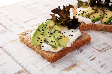 Sandwich with avocado and sesame - healthy breakfast concept