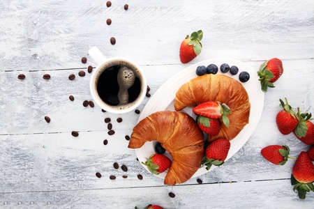 coffee and croissant with coffee beans. breakfast energy conceptの写真素材