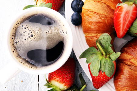 coffee and croissant with coffee beans. breakfast energy conceptの写真素材