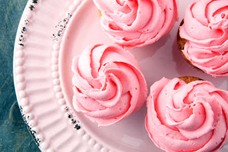 Tasty cupcakes on wooden background. Birthday cupcake in pink colorの写真素材