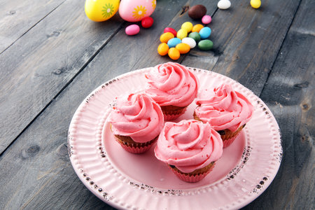 Tasty cupcakes on wooden background. Birthday cupcake in pink colorの写真素材