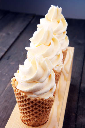 Vanilla frozen yogurt or soft ice cream in waffle coneの写真素材