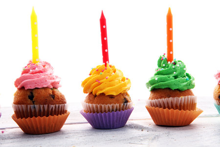 Tasty cupcakes on wooden background. Birthday cupcake in rainbow colorsの写真素材