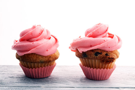 Tasty cupcakes on wooden background. Birthday cupcake in pink colorの写真素材