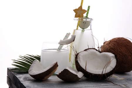 Coconut juice, Drink coconut water and coconuts on wooden backgroundの写真素材