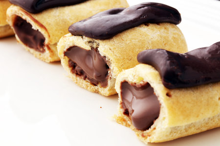 Traditional French dessert. Eclair with chocolate icing. Pastery concept