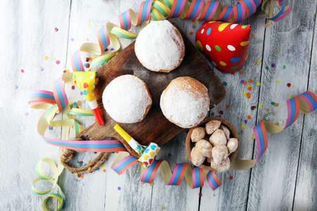 German donuts with jam and icing sugar. Carnival powdered sugar raised donuts with paper streamers.の写真素材