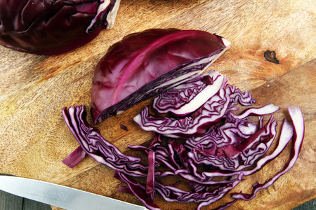 Shredded cabbage, red cabbage on wooden cutting board