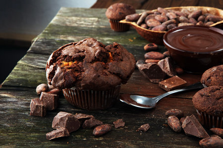 Chocolate muffins, homemade bakery on wooden background