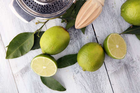 Fresh green lime with half and slice isolated on wooden backgroundの写真素材