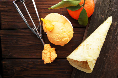 Winter Ice cream with tangerines, on wooden backgroundwith fresh mandarin