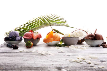 Set of ice cream scoops of different colors and flavours with berries, nuts and fruits の写真素材
