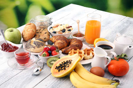 Breakfast served with coffee, orange juice, croissants and fruits. Balanced diet.の写真素材