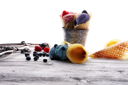 Set of ice cream scoops of different colors and flavours with blueberries, raspberries and...