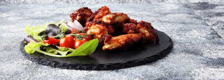 crispy barbecue chicken wings bbq on grey backgroundの写真素材