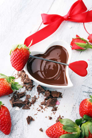 Valentine Chocolate fondue melted with fresh strawberries and dark chocolate and rosesの写真素材