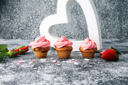 Delicious cupcake for Valentine Day. cake for Valentines day with chocolate and strawberries. Traditional homemade with red rosesの写真素材