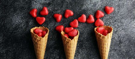 Valentine day candy with red hearts and conesの写真素材