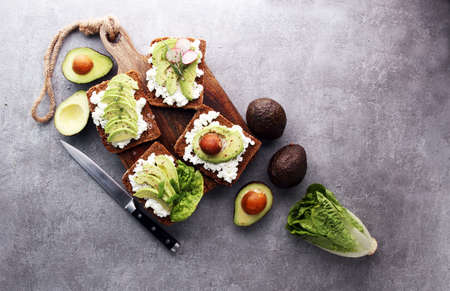 sliced avocado on toast bread with spicesの写真素材