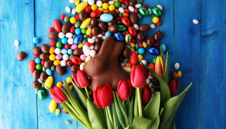 Chocolate Easter eggs and bunny with fresh easter flowerの写真素材