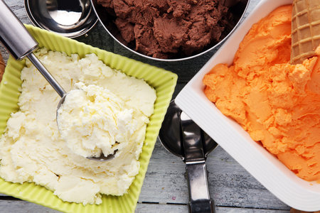 Set of ice cream scoops of different colors and flavours with chocolate, vanilla and fruits の写真素材