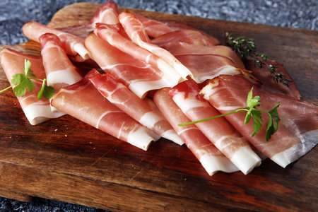 Italian prosciutto crudo or jamon with parsley. Raw ham.の写真素材