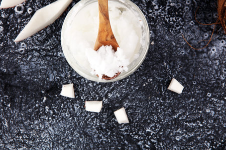 coconut oil and fresh coconuts on grey backgroundの写真素材