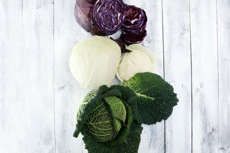 Three fresh organic cabbage heads. Antioxidant balanced diet eating with red cabbage, white cabbage and savoyの写真素材