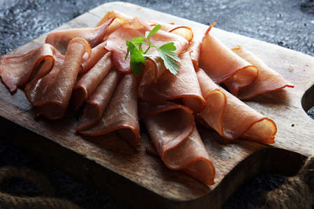 Italian prosciutto crudo or jamon with parsley. Raw ham.の写真素材