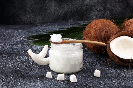 coconut oil and fresh coconuts on grey backgroundの写真素材