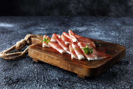 Italian prosciutto crudo or jamon with parsley. Raw ham.の写真素材