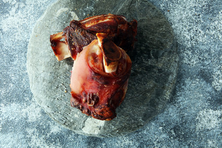Roasted pork knuckle. Ham and bacon are popular foods in the west. German Schweinshaxe or Haxe